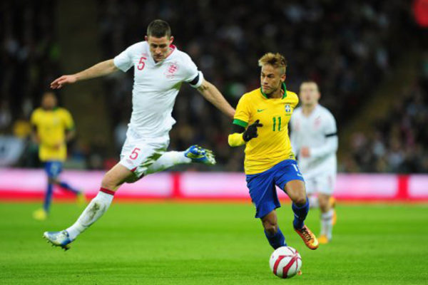 England's Gary Cahill and Brazil's Junior Neymar (right) battle for the ball